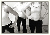 Three women exercising; cropped to only show torsos